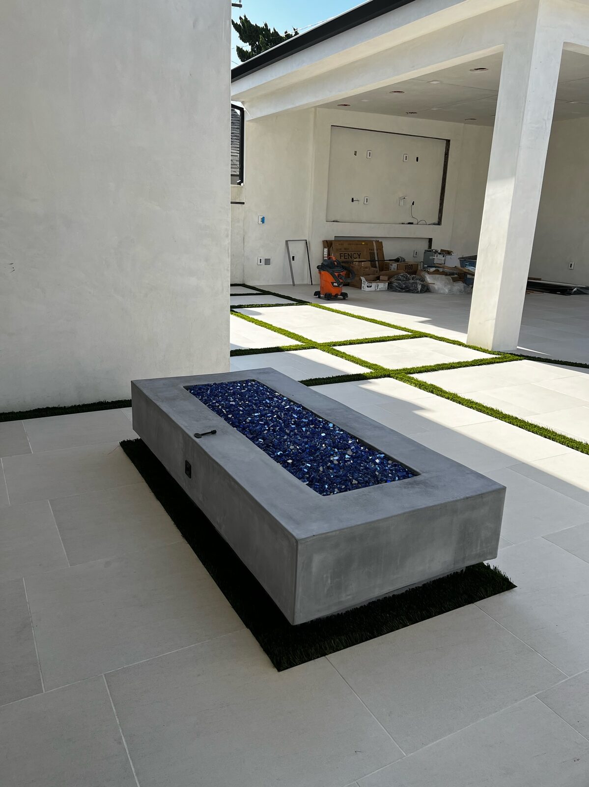 Modern linear fire pit with blue fire glass