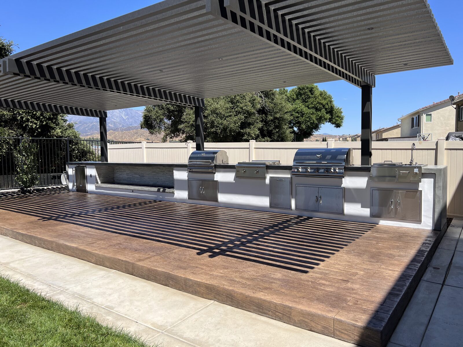 Custom outdoor kitchen under pergola